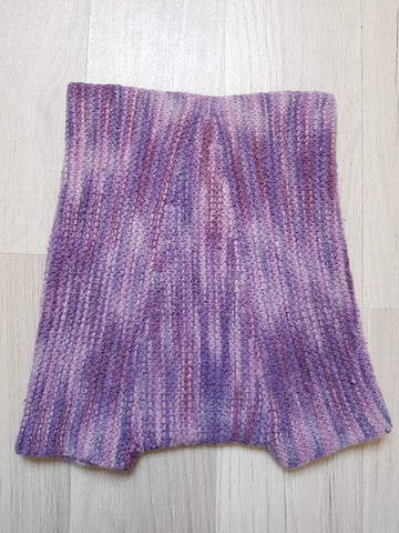 Violetin kirjavat villahousut takapuolelta.